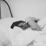 Woman lying in bed in depression