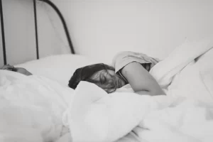 Woman lying in bed in depression