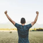 Man with arms raised, triumphant