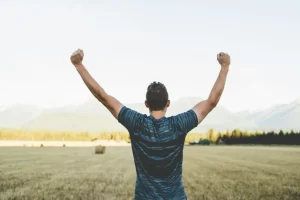 Man with arms raised, triumphant