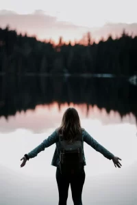 Woman's Arms Open by a lake.